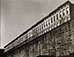 <em>Row of Buildings with Wall</em><br>Gelatin silver print</br>Image: 3 1/2 x 4"; Paper: 4 x 5"